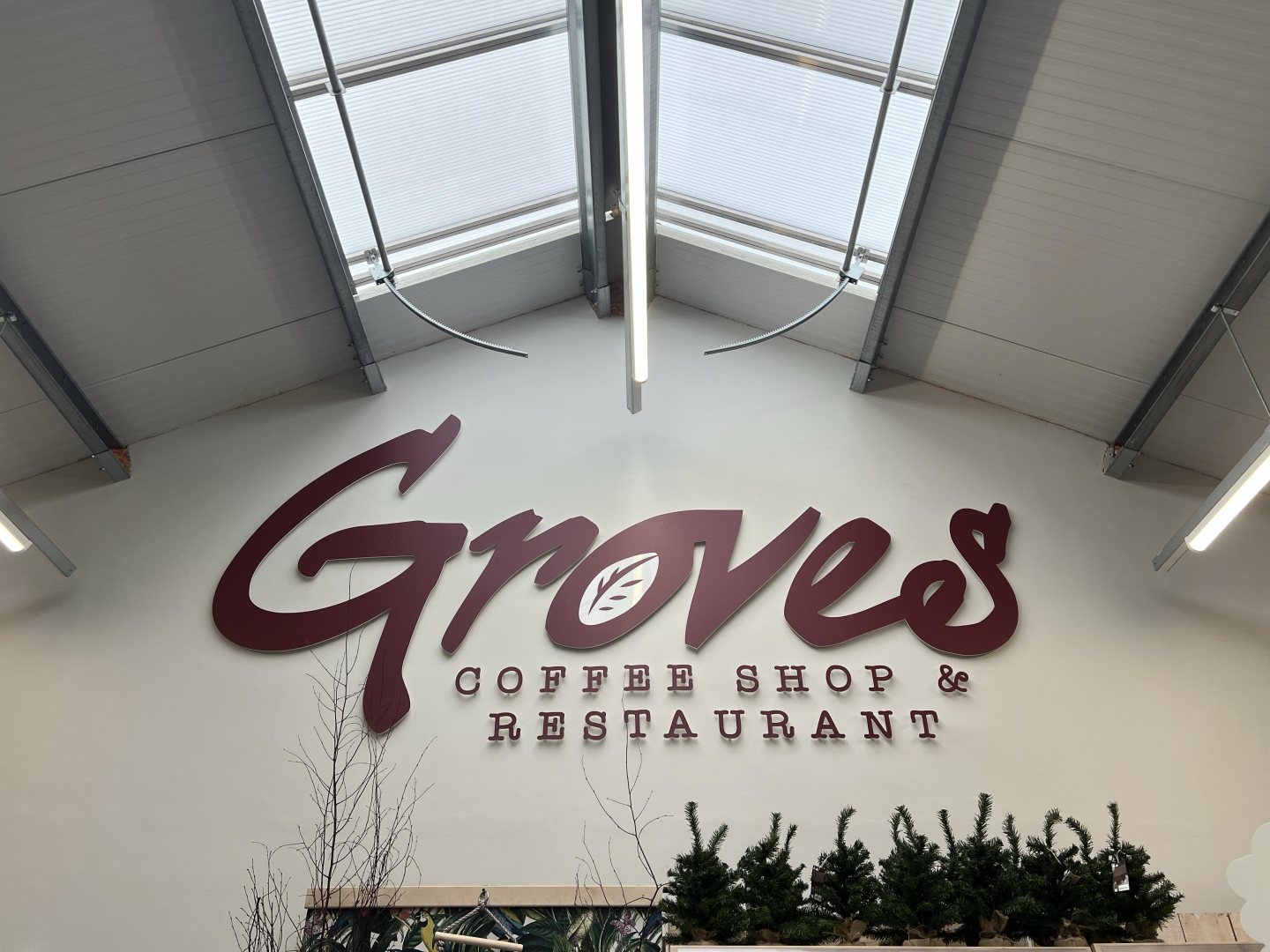 Large burgundy 3D Groves Coffee Shop & Restaurant lettering installed on an interior wall.