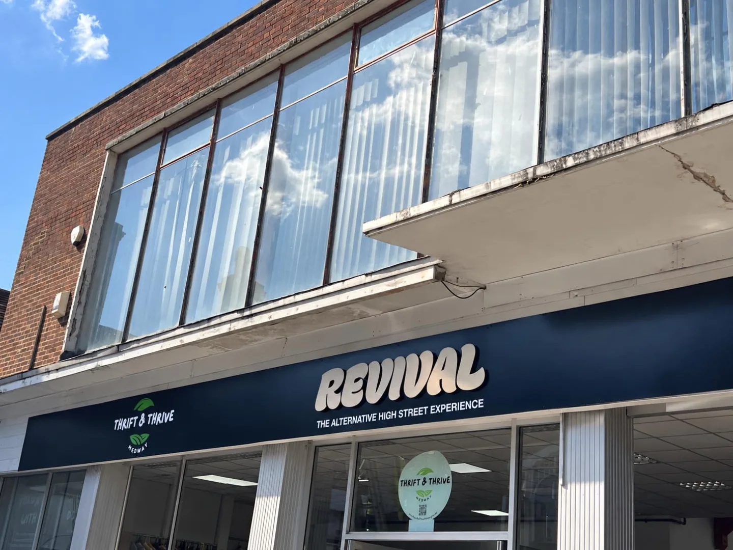 Completed Revival shopfront signage in Chatham, Kent, featuring raised brushed bronze-effect ACM lettering on a matt black fascia alongside the green and white Thrift & Thrive Medway logo.