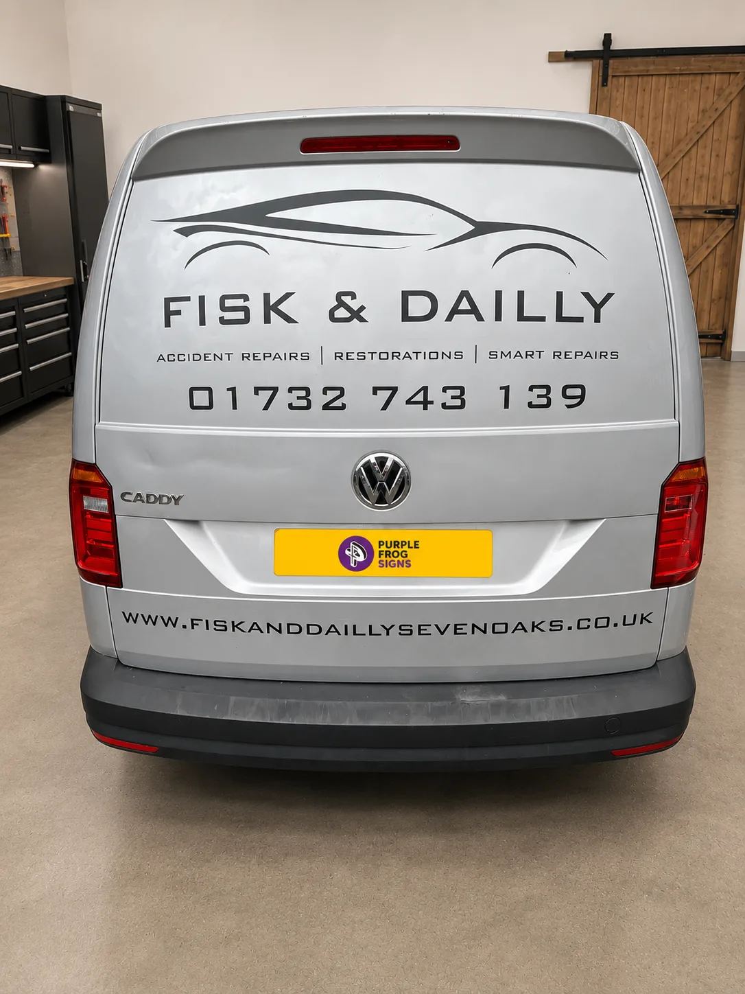 Angled view of a commercial van with simple matt black vinyl branding applied by Purple Frog Signs Ltd for a smart professional finish.