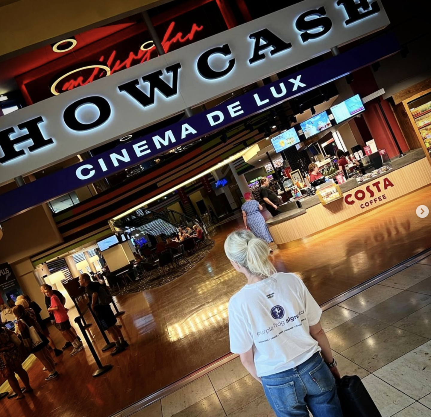 Purple Frog Signs team member conducting a signage site survey at the entrance to Showcase Cinema de Lux.