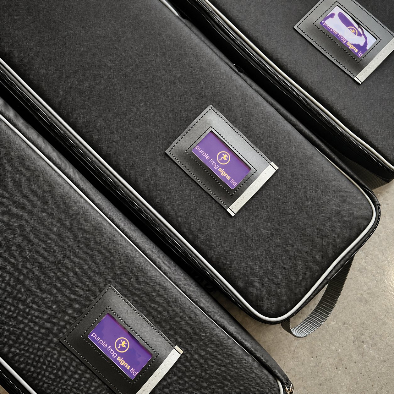 Purple Frog Signs roller banners packed in protective carry cases, ready for delivery to a client as a supply-only order.